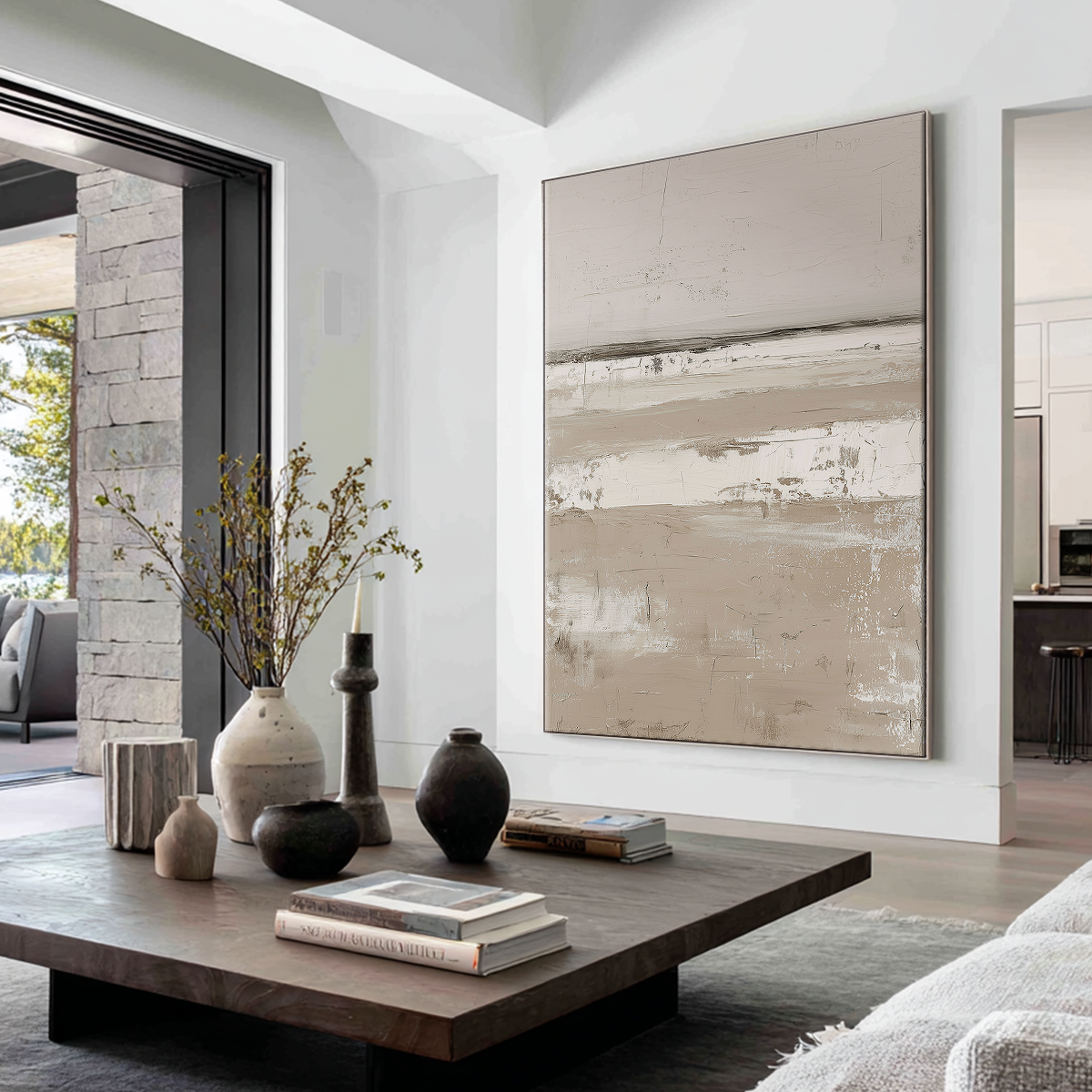 A styled living room featuring two large framed abstract floral wall art prints in black, white, and beige tones, hung above a light beige sofa. The room is decorated with warm wall sconces, a wooden coffee table, and a window with sheer curtains.