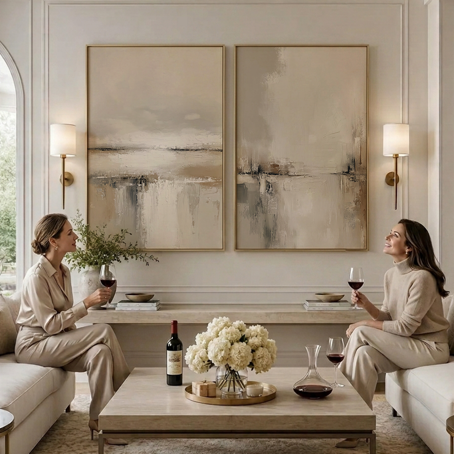 Neutral Landscape Wall Art Set of 2 | Minimalist Abstract featuring two neutral abstract canvases above a refined living room seating area with two people relaxing