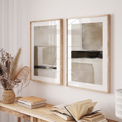Minimalist Japandi Wall Art Set | Beige & Black Abstracts displayed as two framed neutral abstract art prints above a wooden console with books and dried grasses