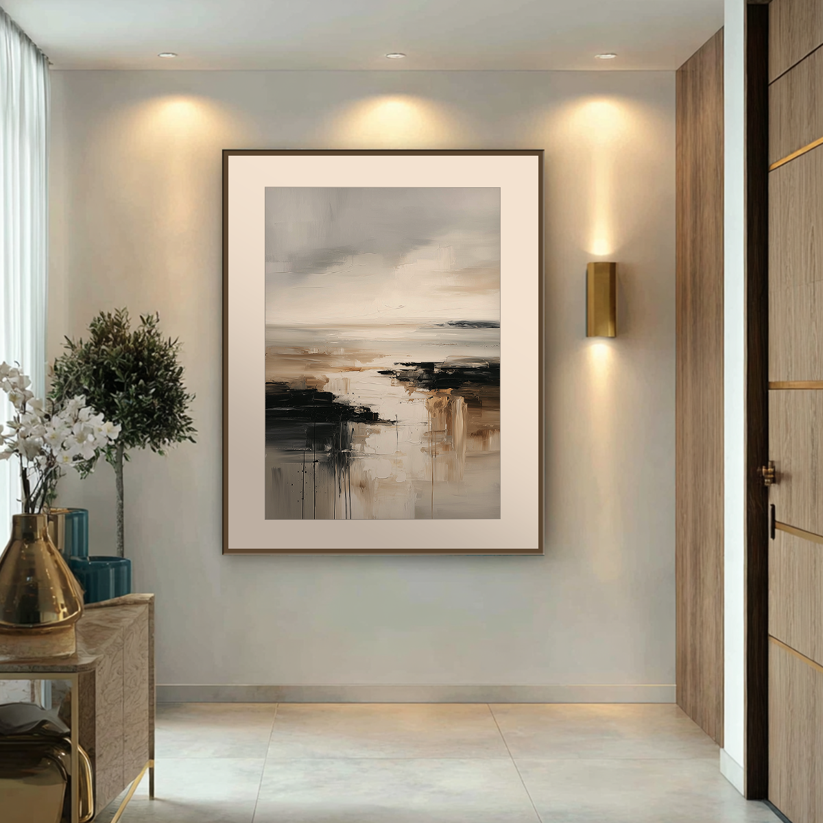 Neutral abstract landscape canvas print hanging in a hallway beside a window with soft natural light