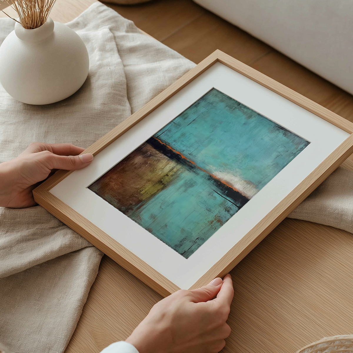 Abstract Landscape Wall Art | Modern Textured Canvas Print | Contemporary Neutral Decor featuring a minimalist abstract design in teal, brown, and orange tones being held above a wooden surface.