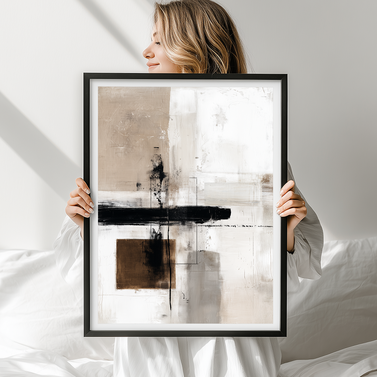 Woman holding a framed Urban Echo | Minimalist Abstract Art Print | Beige, Black & Brown Geometric Brushstroke | Giclee, Canvas & Poster Print | Matte | Framed or Unframed with abstract beige and black brushstrokes, perfect modern wall art.