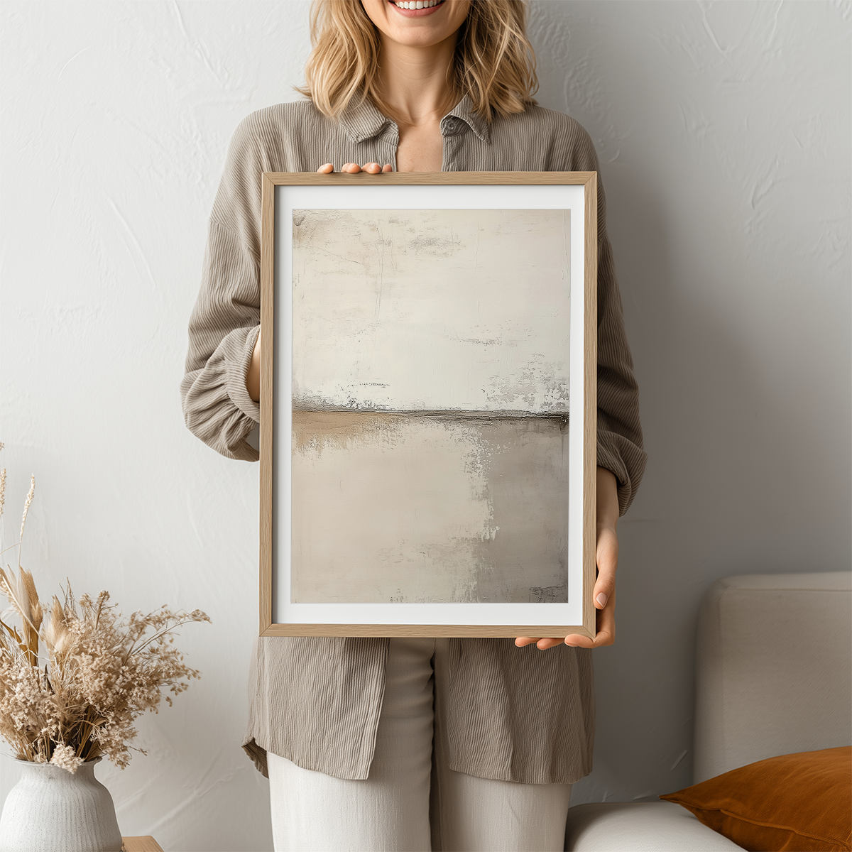 Woman holding a Neutral Abstract Wall Art Print - Scandinavian Modern Beige Canvas Wall Decor featuring minimalist beige and gray tones with soft textured abstract design.