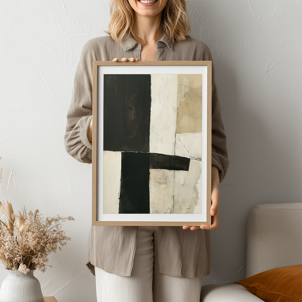 Person holding framed Geometric Abstract Wall Art | Neutral Black Beige Minimalist Print | Modern Wabi-Sabi Decor featuring bold black, beige, and cream abstract shapes in a minimalist style.