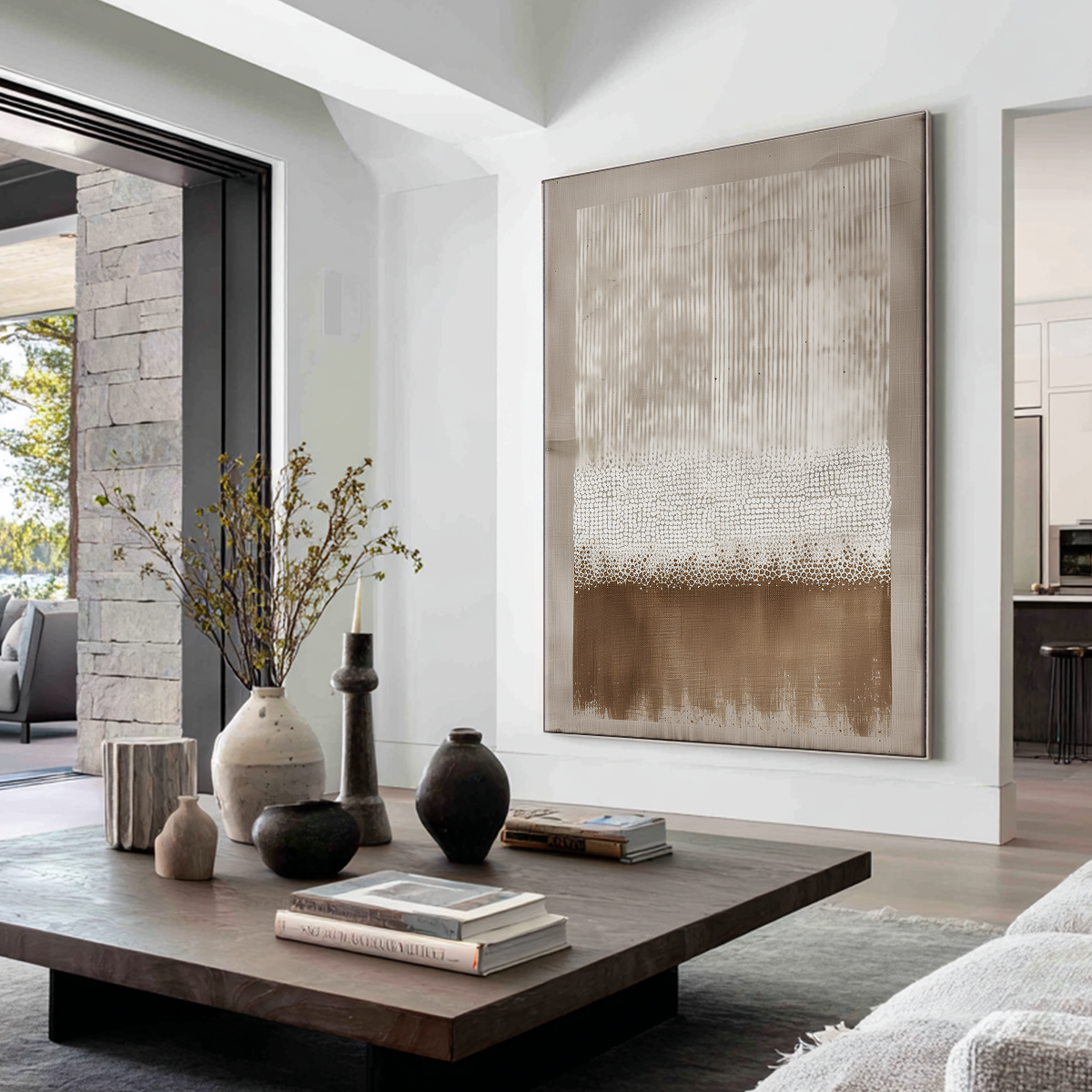 Large vertical abstract canvas wall art in warm beige, taupe, and brown tones hanging on a white wall in a modern living room with a wooden coffee table and neutral decor.