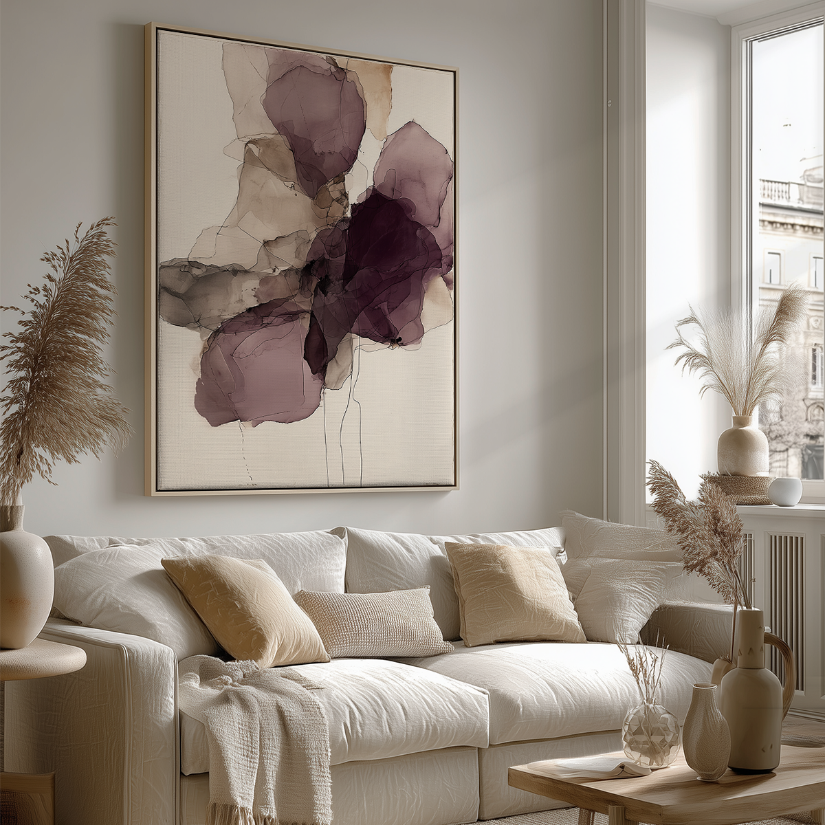 Ink Wash Abstract Floral Wall Canvas Art Print - Burgundy Minimalist Modern Wall Art featuring delicate burgundy and neutral ink wash floral shapes in a wooden frame above a cozy beige sofa in a stylish living room.