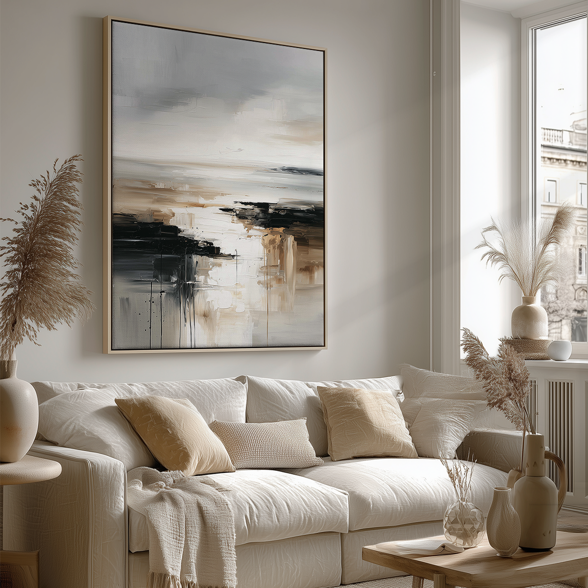 Neutral abstract landscape canvas print in an oak frame hanging above a couch in a modern living room