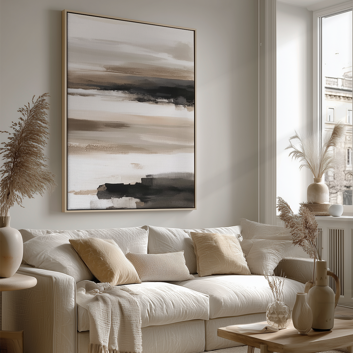 Abstract Horizon Wall Art | Neutral Watercolor Landscape hanging above a cream sofa with beige and light brown pillows in a modern living room featuring minimalist decor and natural light.