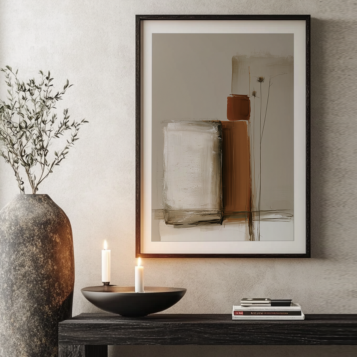 A framed abstract art print with a black frame and white mat, hanging on a textured light gray wall above a dark wooden console table. The print features minimalist geometric shapes in beige, brown, and white.