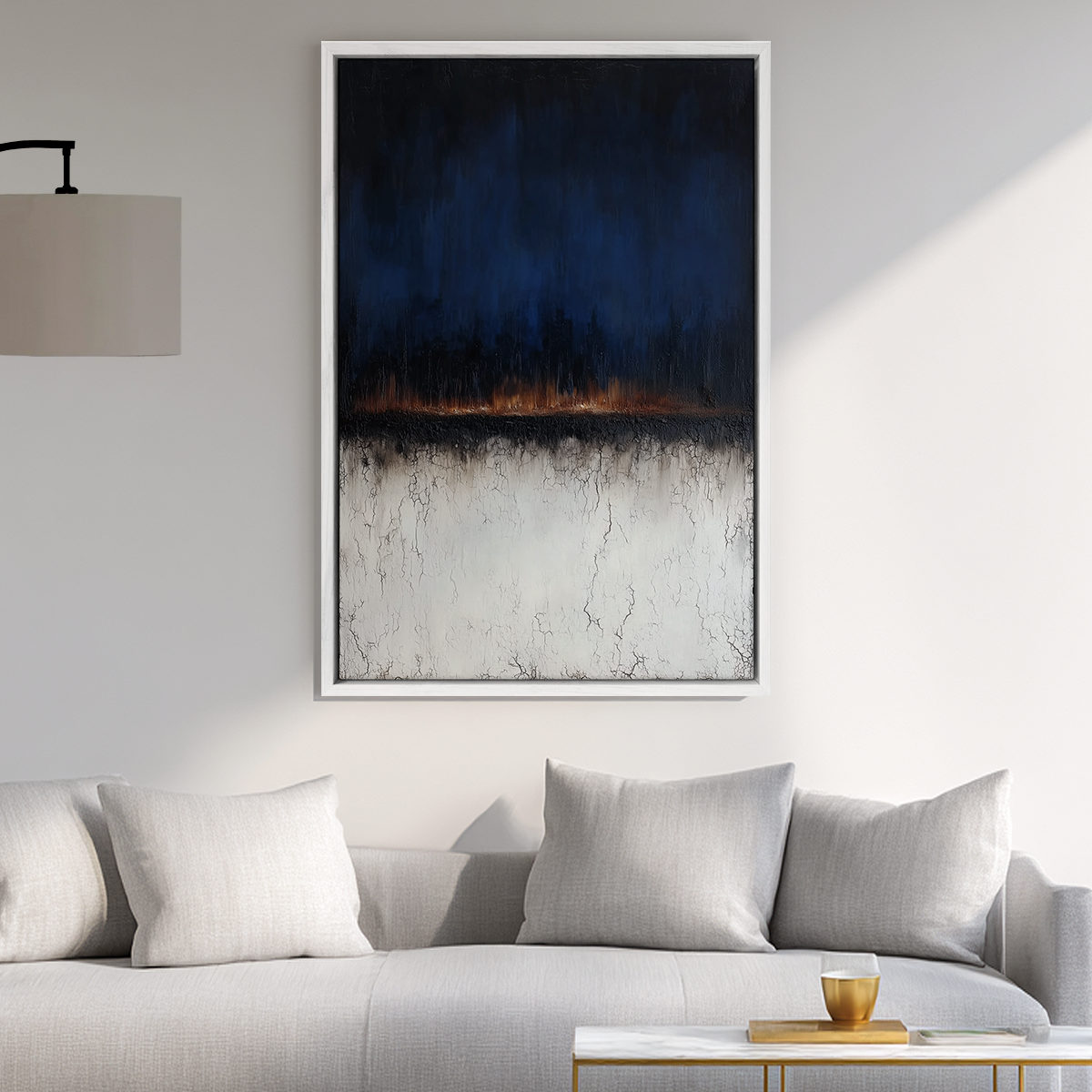 Moody Horizon Abstract Wall Art | Dark Minimalist Landscape Print | Navy & Burnt Orange Decor featuring a textured dark blue and burnt orange horizon above a cracked white lower half, hanging above a light gray couch in a modern living room.